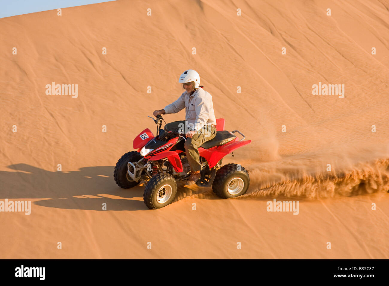 Quad biking on sand dunes near Swakopmund a coastal city halfway up Namibia Atlantic coast in Africa Stock Photo