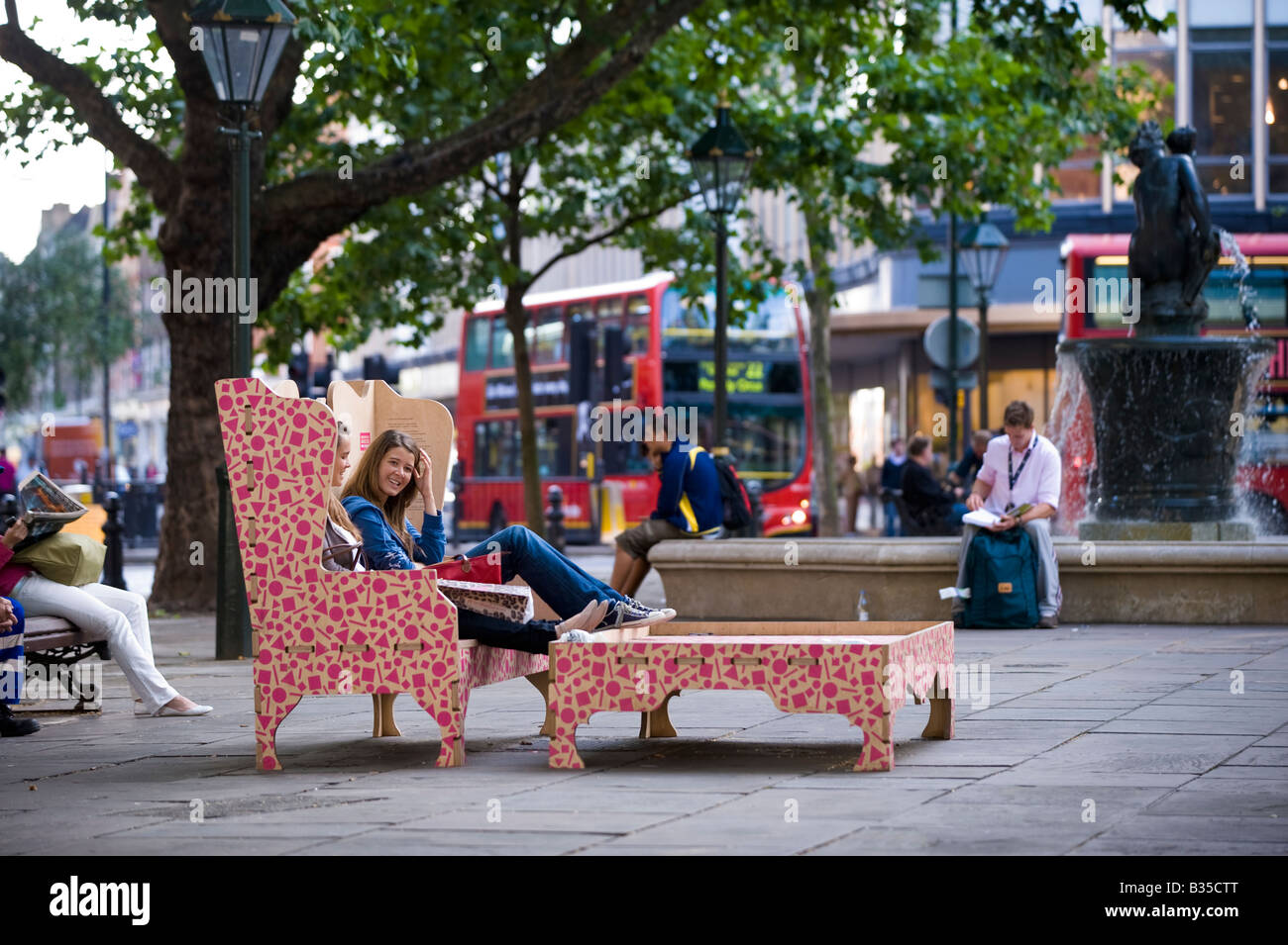 People relaxing on Sloane Square Chelsea SW3 London United Kingdom Stock Photo