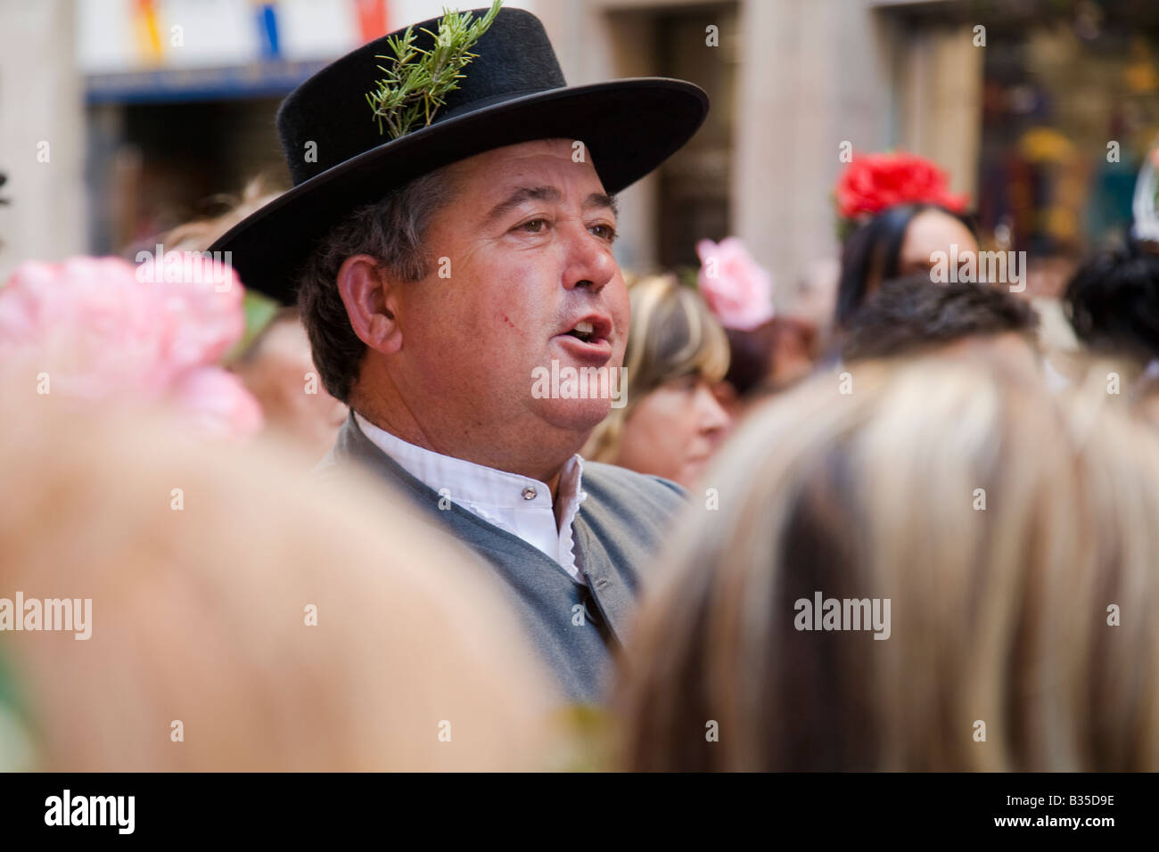 SPAIN Barcelona Man in traditional hat and suit sing as part of crowd in street Day of Ascension celebration holy day Stock Photo