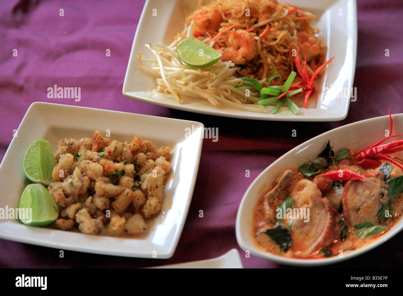 Thai Food Deep Fried Squid Szechuan Duck Dip Sauces Stir Fried fresh vegetables dish in a restaurant setting Stock Photo