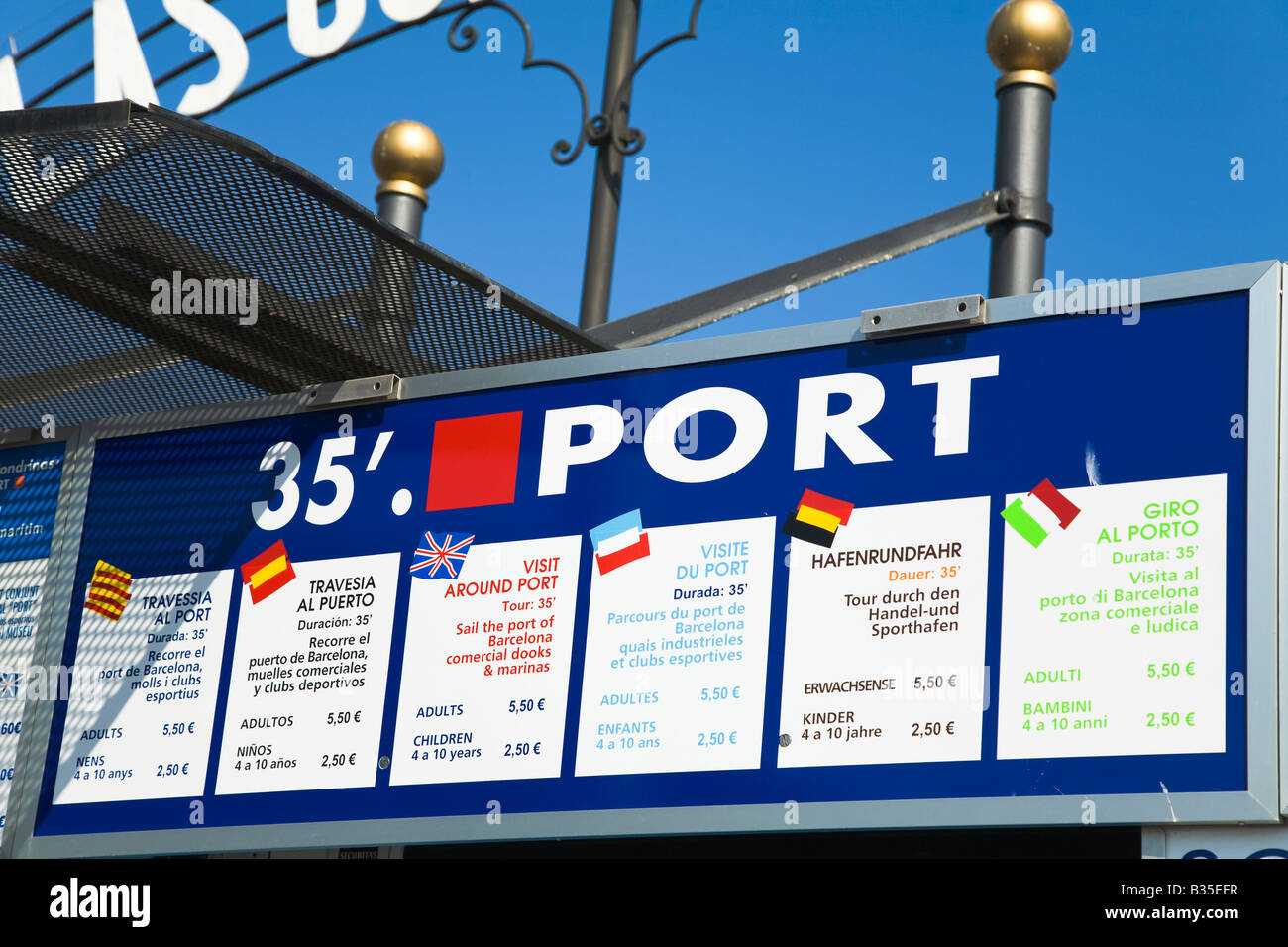 SPAIN Barcelona Sign in six different languages describe available boat tours in Marina Port Vell prices in Euros Stock Photo