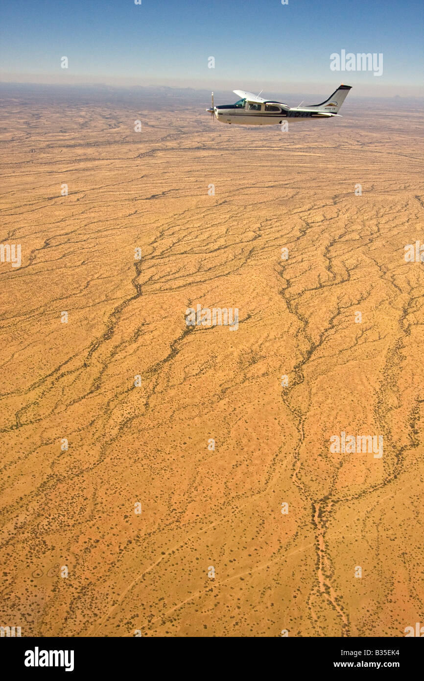 Aerial view of desert landscape of north central Namibia Africa with a small airplane in view Stock Photo