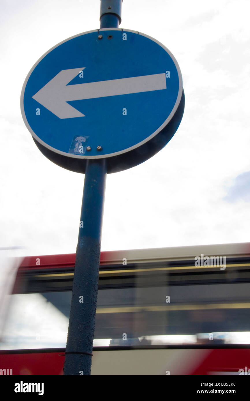 left Arrow signal with London red bus Stock Photo