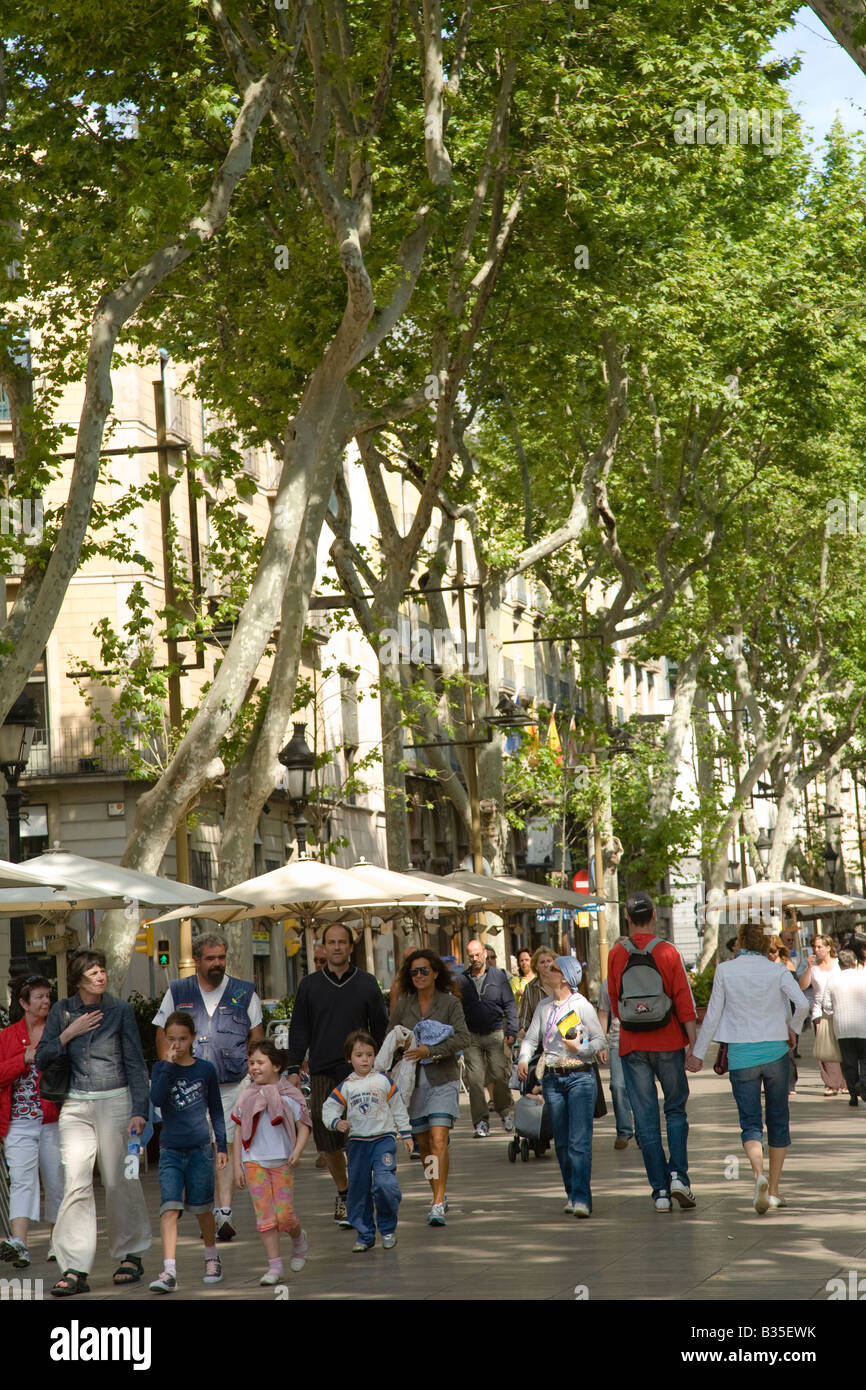 SPAIN Barcelona People strolling down the Ramblas pedestrian walkway in the heart of the city popular tourist destination Stock Photo