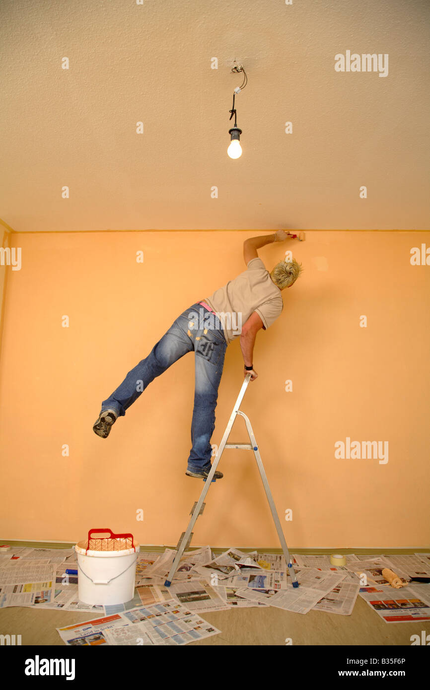 Young man painting the walls in his flat Stock Photo