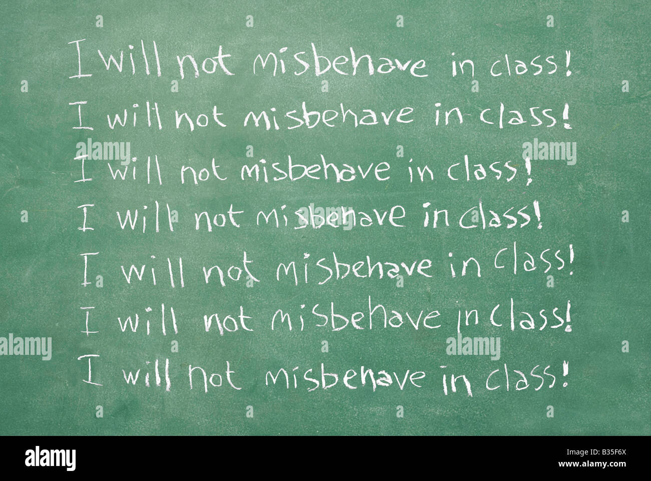 Old chalkboard with the sentence I will not misbehave in class written