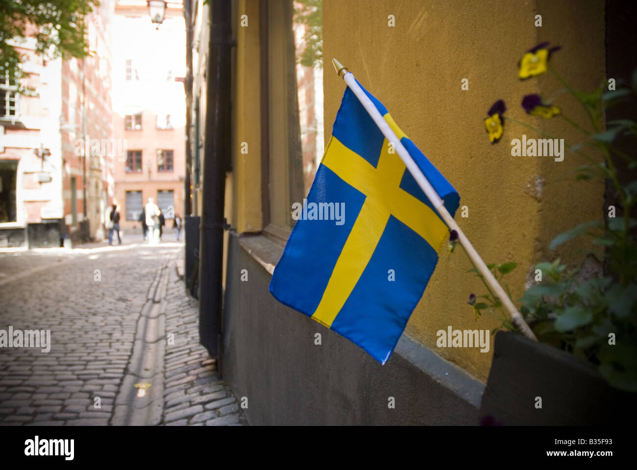 A Swedish flag is stuck to a window box in the Gamla Stan Old Town area of Stockholm, Sweden. Stock Photo