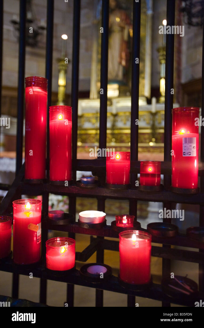 SPAIN Barcelona Many red votive candles lit in interior of Cathedral of Barcelona Gothic architecture built in 14th century Stock Photo