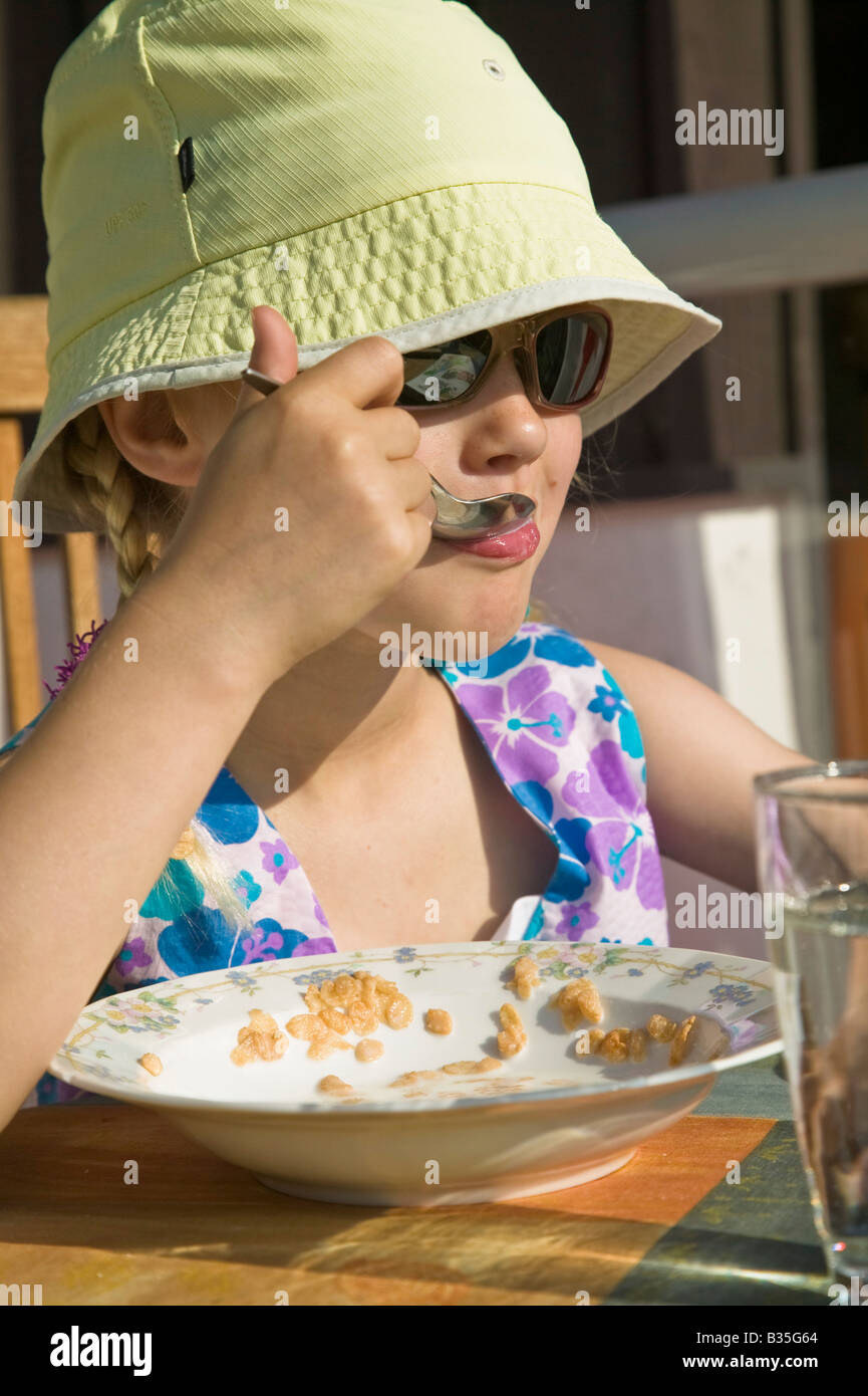 Girl eating cereal for breakfast Stock Photo