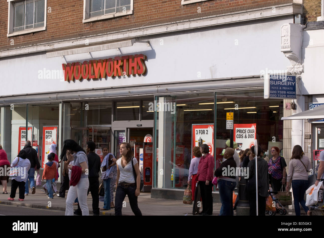 Shops and pedestrians on Kilburn High Road NW6 London United Kingdom