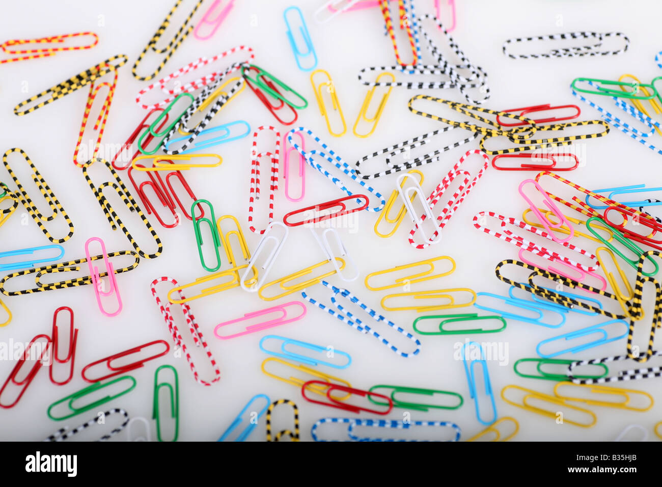 Coloured and patterned paper clips on a white background Stock Photo