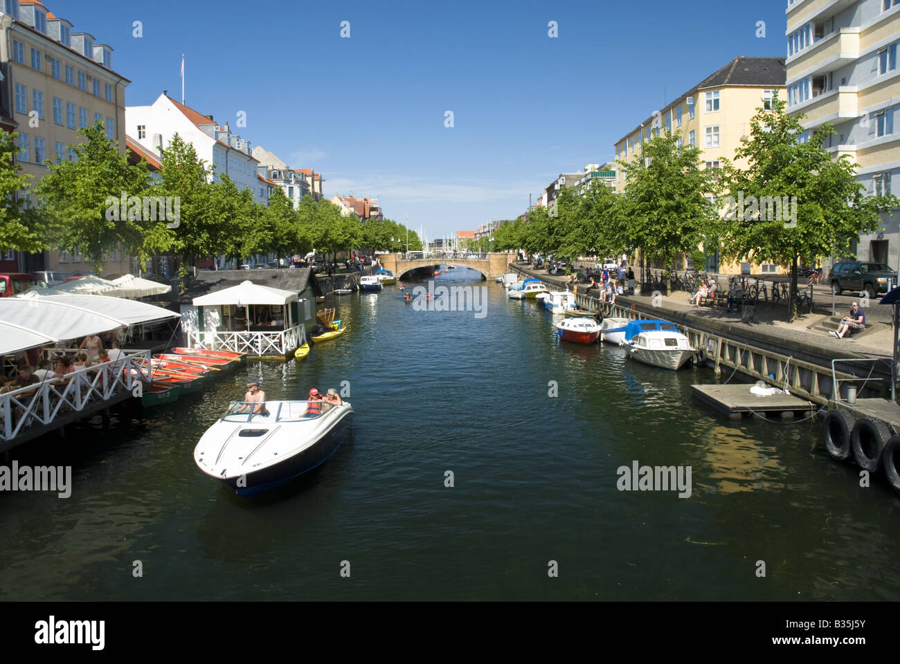 A power boat cruises down the Christianshavn canal in Copenhagen Denmark. Stock Photo