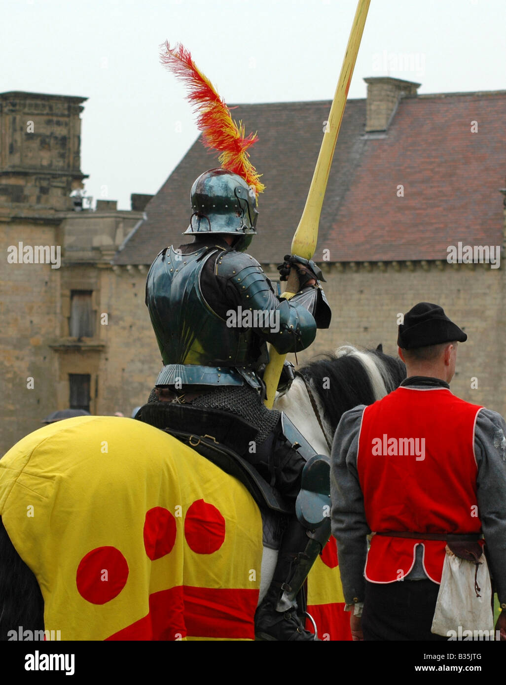 Knight holding lance with squire Stock Photo