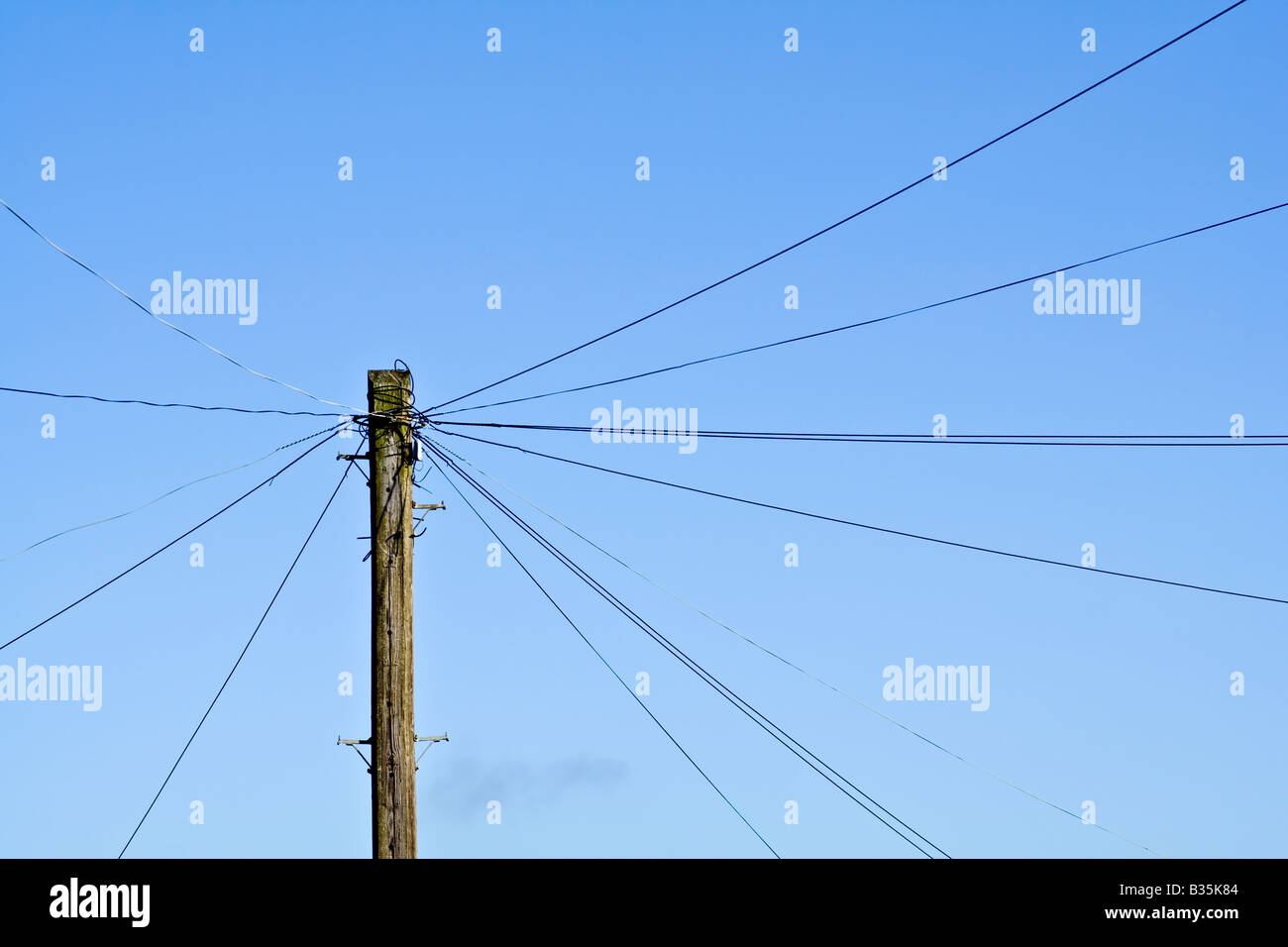 A telegraph pole against a blue sky Stock Photo - Alamy