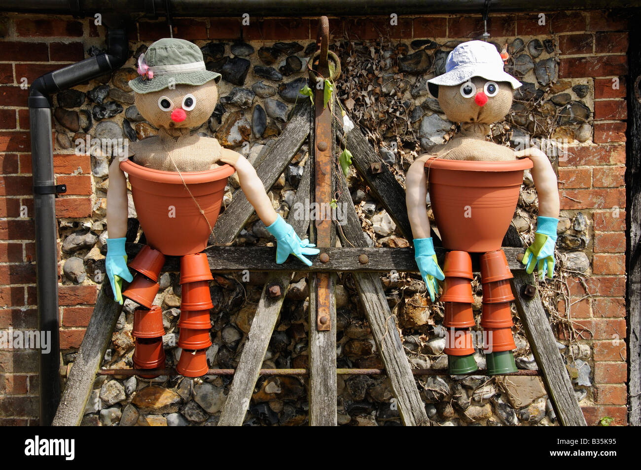 Comical flowerpot men feature in a country garden Stock Photo