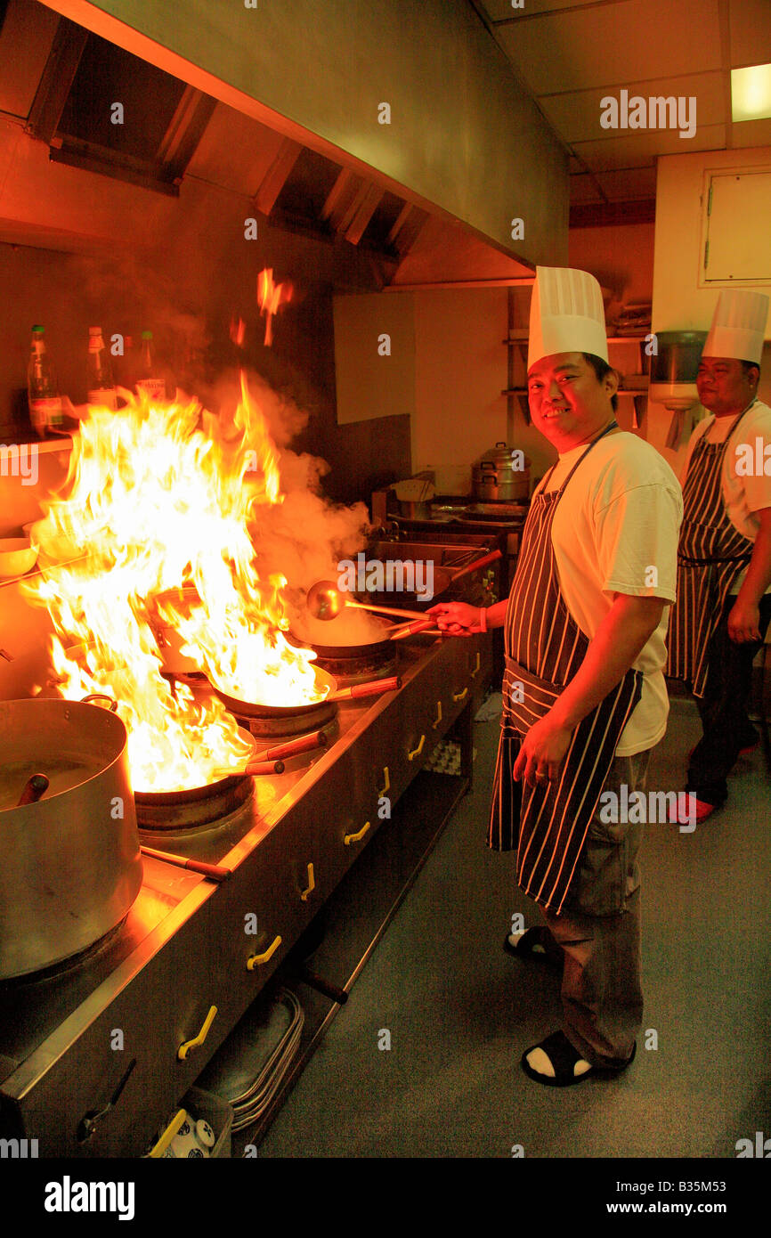 Male Thai Chef cooking with flaming wok in a restaurant kitchen, Oriental  Cuisine Stock Photo - Alamy