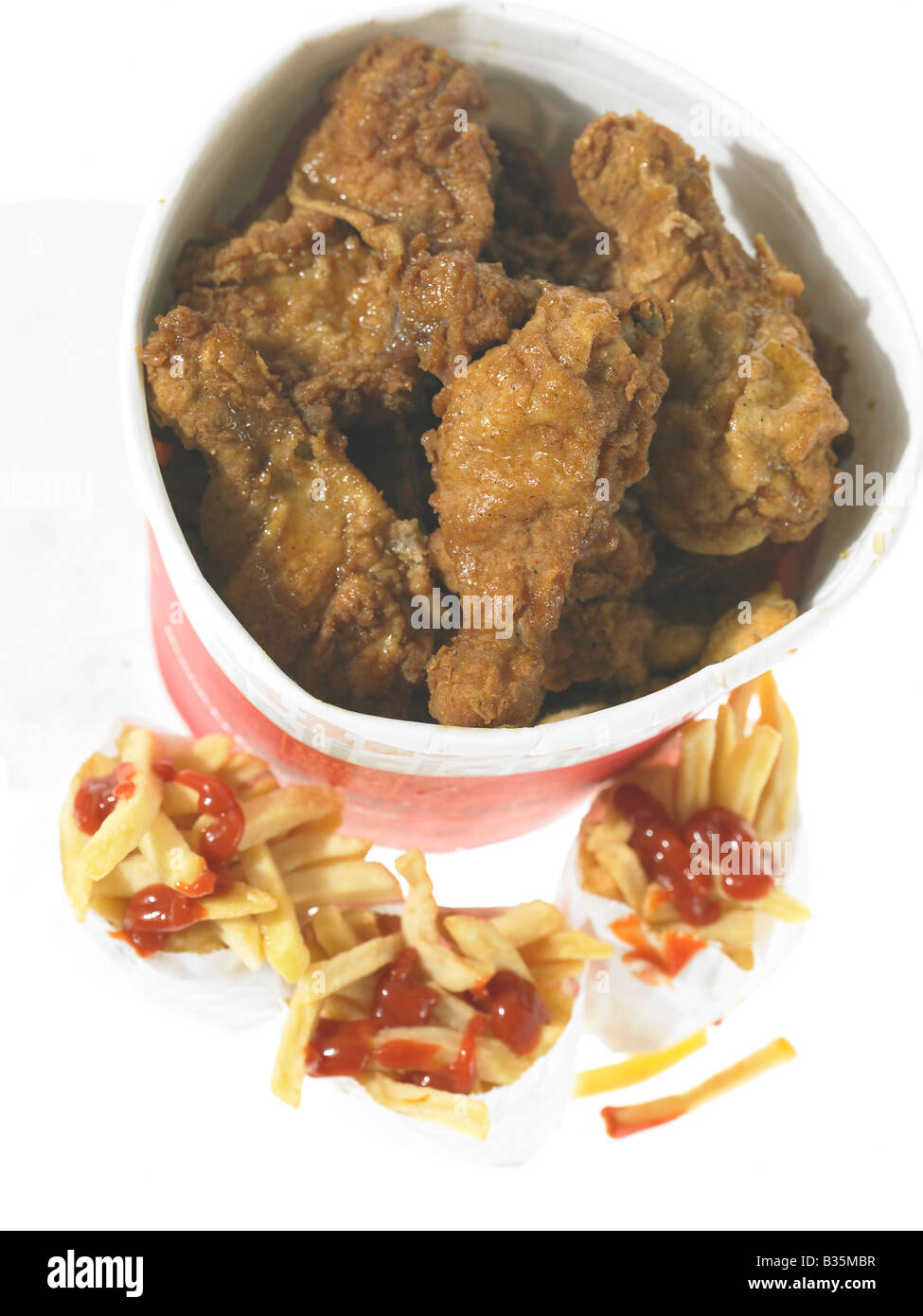 Bucket of Fried Chicken and French fried Chips in take out packaging Stock Photo