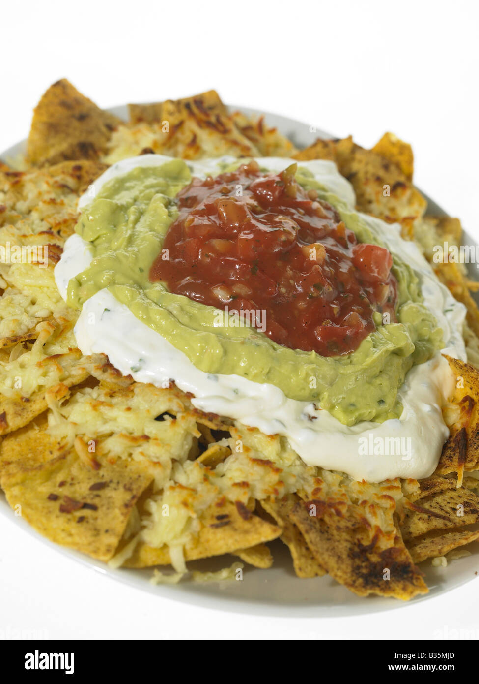 Nacho Chips with sour cream guacamole and salsa Stock Photo Alamy