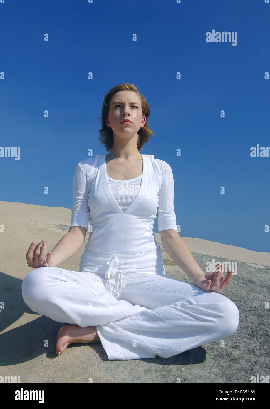 Young woman practicing yoga in the lotus position Stock Photo - Alamy