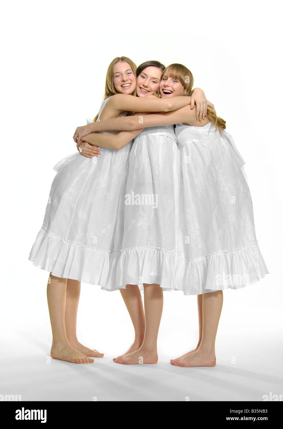 Portrait of three young women hugging each other and smiling Stock ...