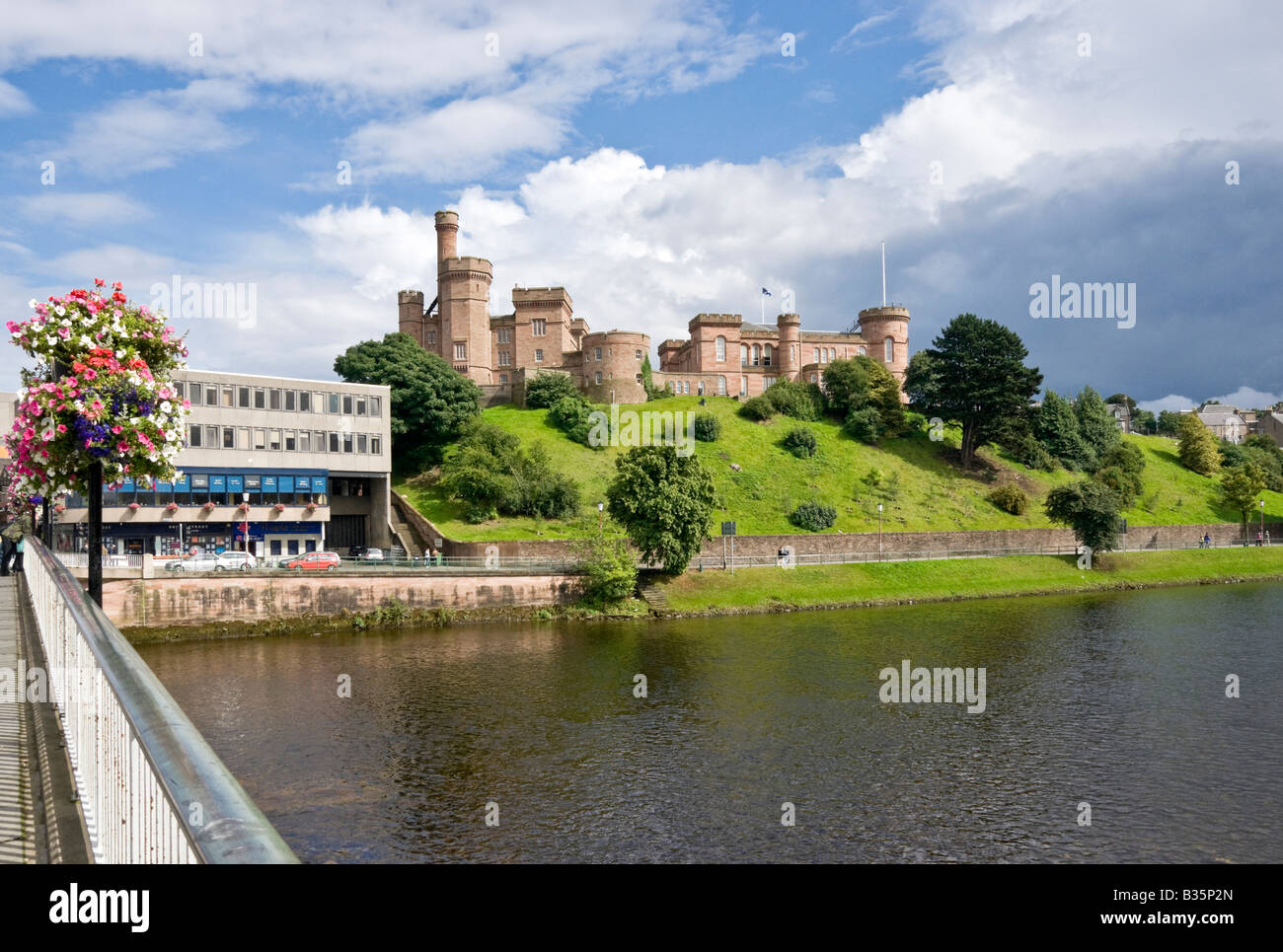 Inverness Castle viewed from bridge spanning River Ness in Inverness Scotland on a sunny summer afternoon Stock Photo
