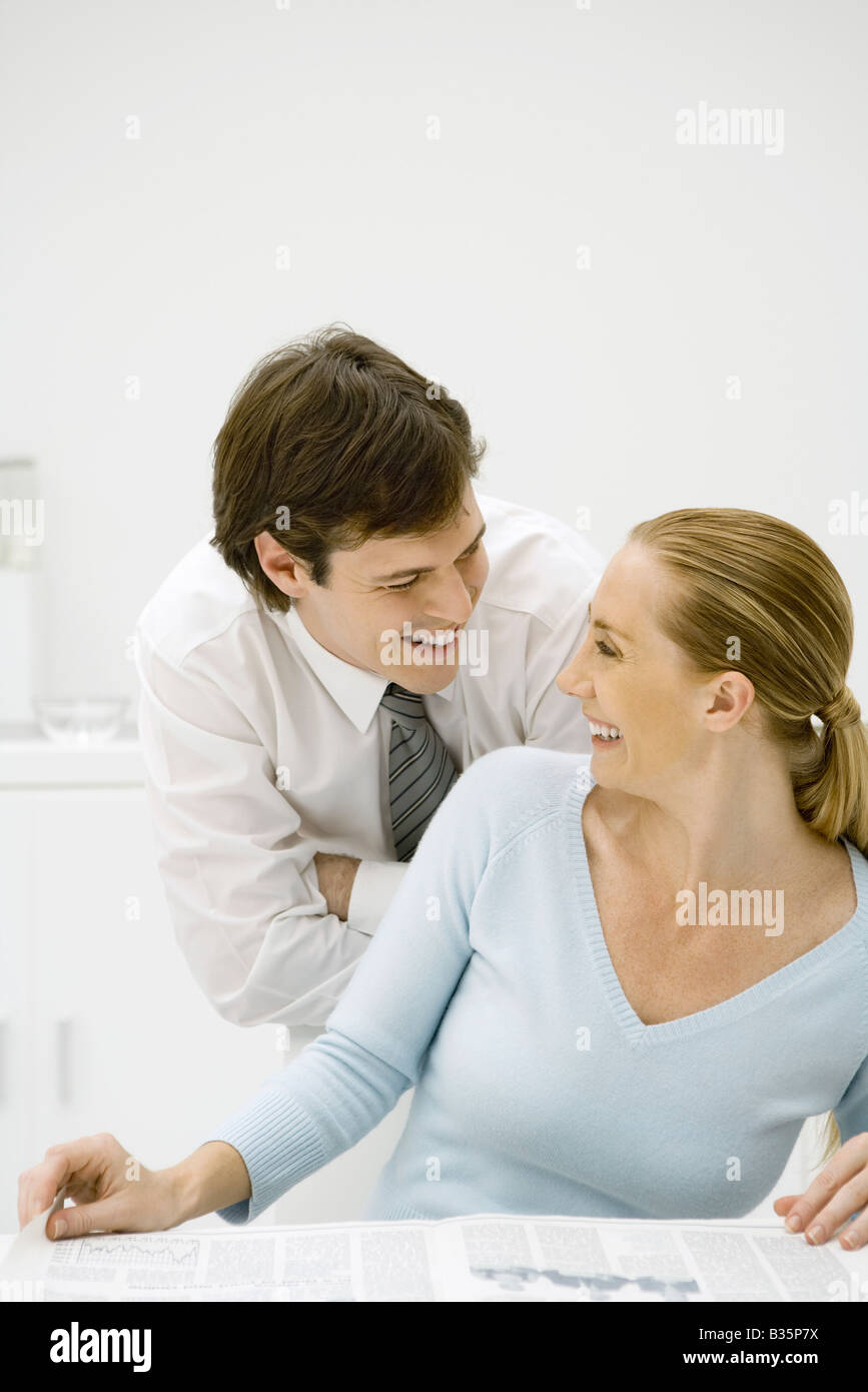 Couple smiling at each other, woman looking back over her shoulder Stock Photo