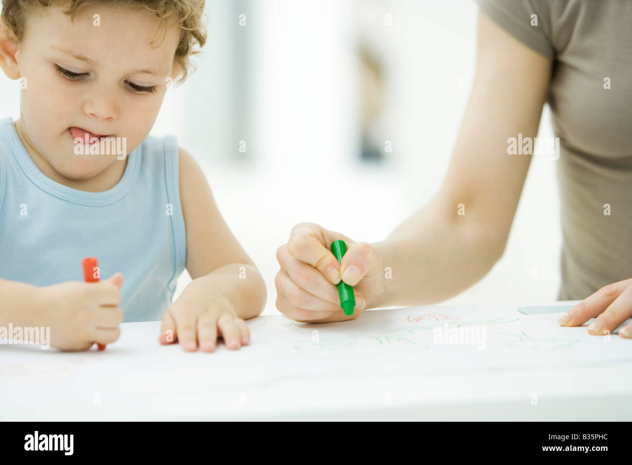 Mother And Son Coloring With Crayons Together Boy Sticking Tongue Stock Photo Alamy