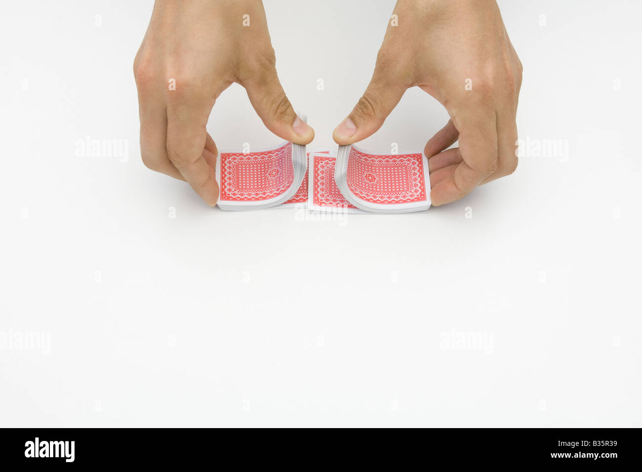Pair of hands shuffling cards, cropped view Stock Photo Alamy