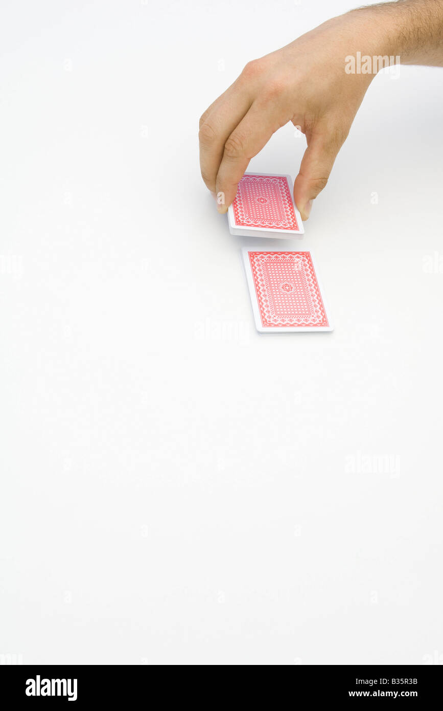 Hand cutting a deck of cards, cropped view Stock Photo