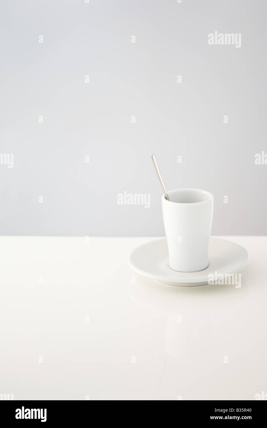 Cup resting on saucer, spoon in cup Stock Photo Alamy
