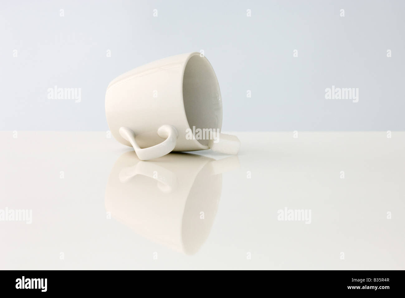 Coffee cup lying on its side, sugar cube spilling out Stock Photo Alamy