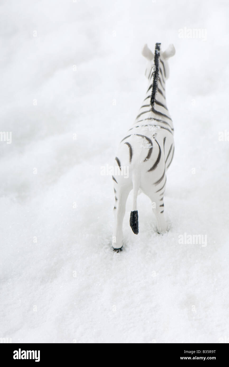 Toy zebra in snow, rear view Stock Photo