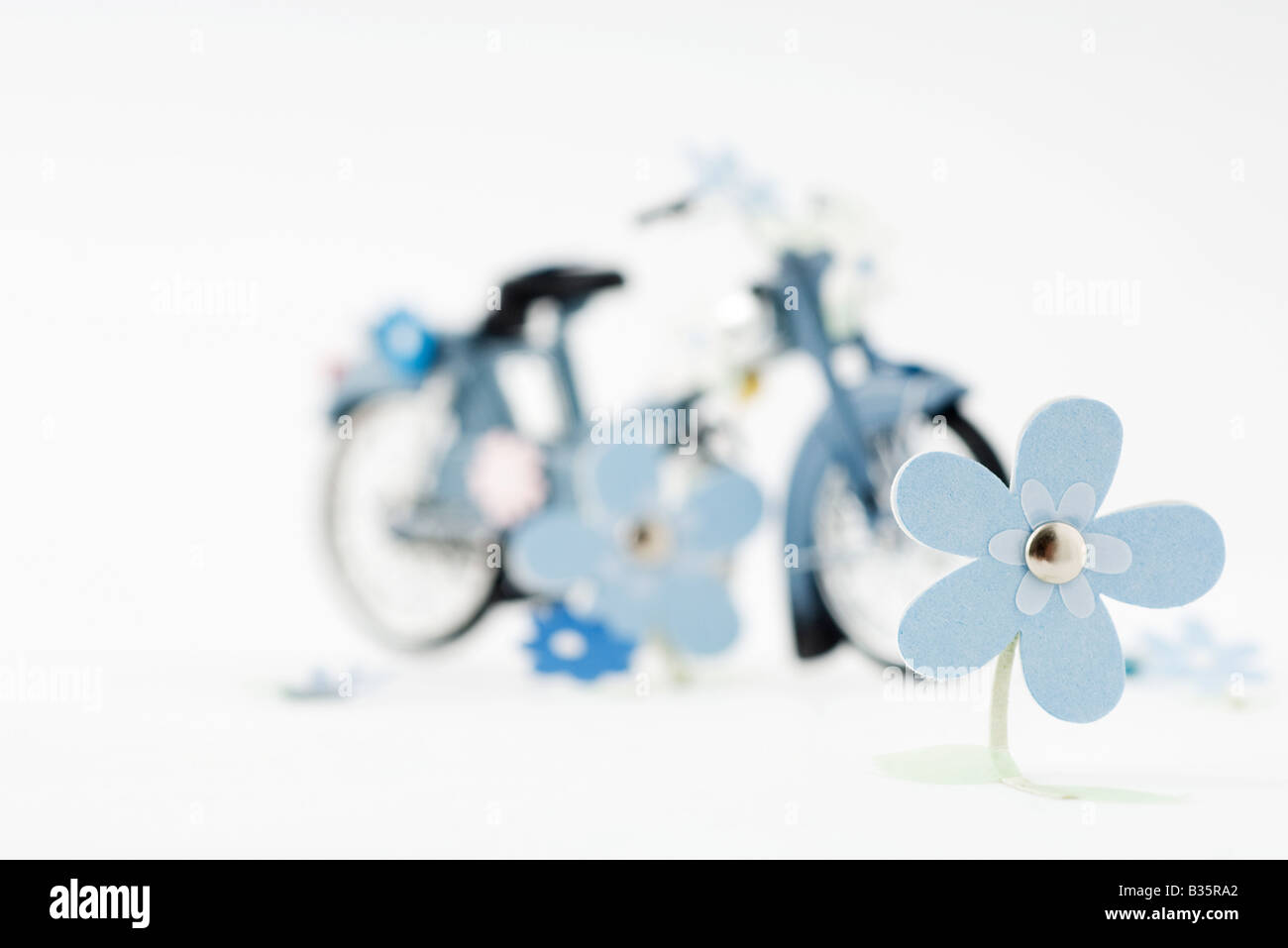 Craft flowers, toy bike in background Stock Photo