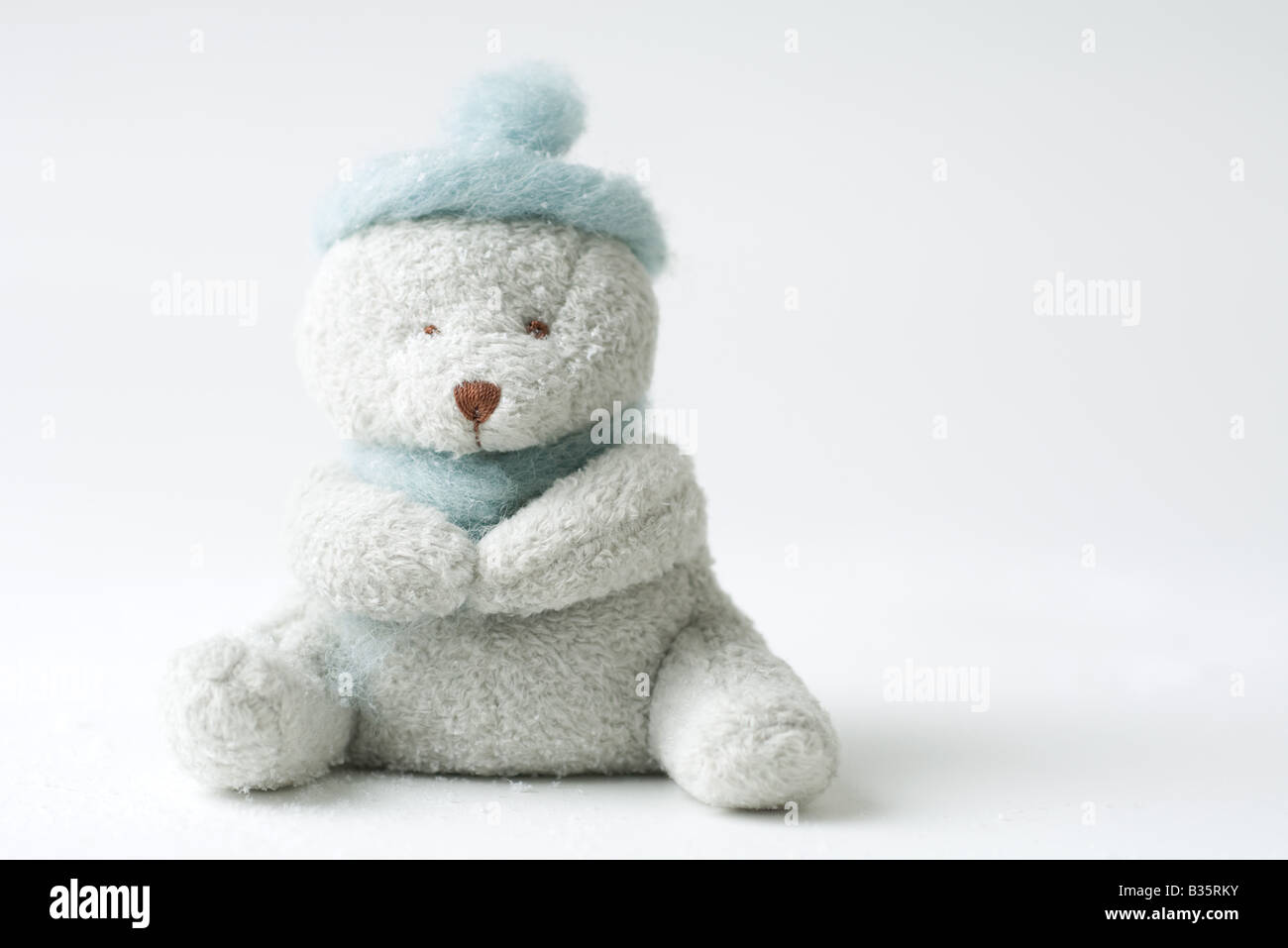 Teddy bear wearing hat, missing one eye Stock Photo