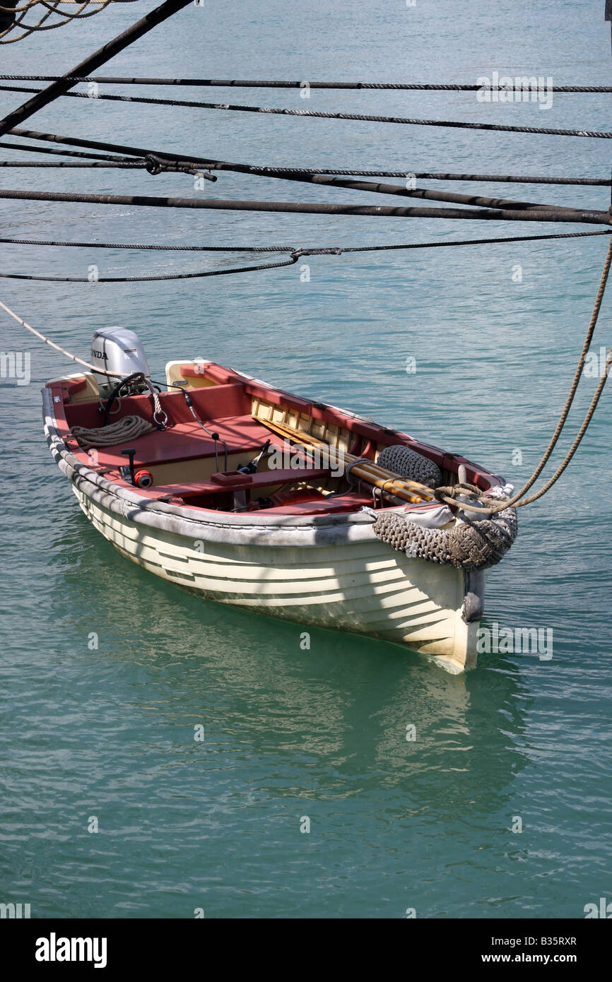 A dingy boat tied up to the US Brig Niagara Stock Photo