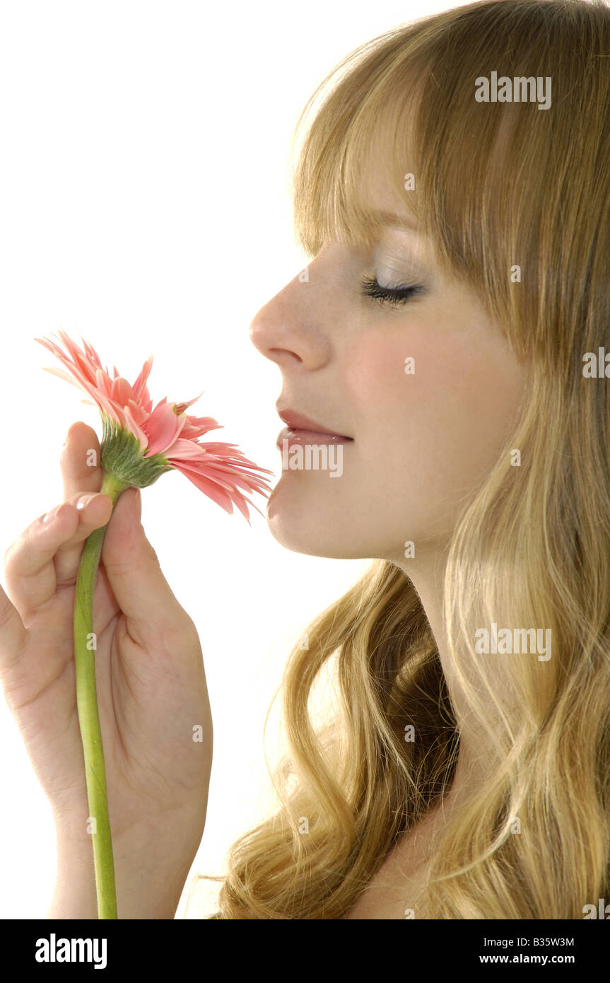 Woman smelling pink flower hi-res stock photography and images - Alamy