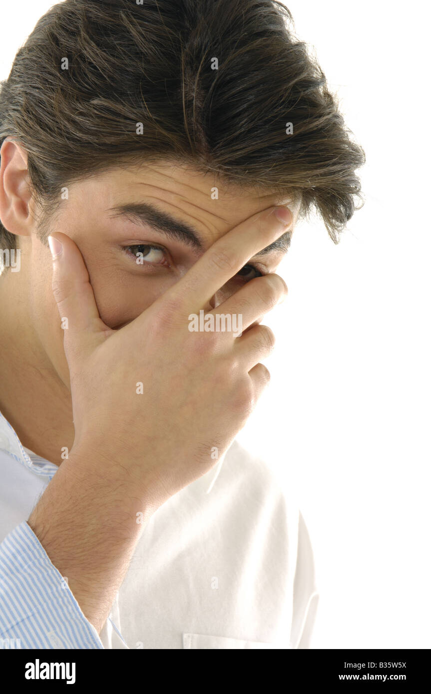 Portrait of a young man covering his face with his hand Stock Photo - Alamy