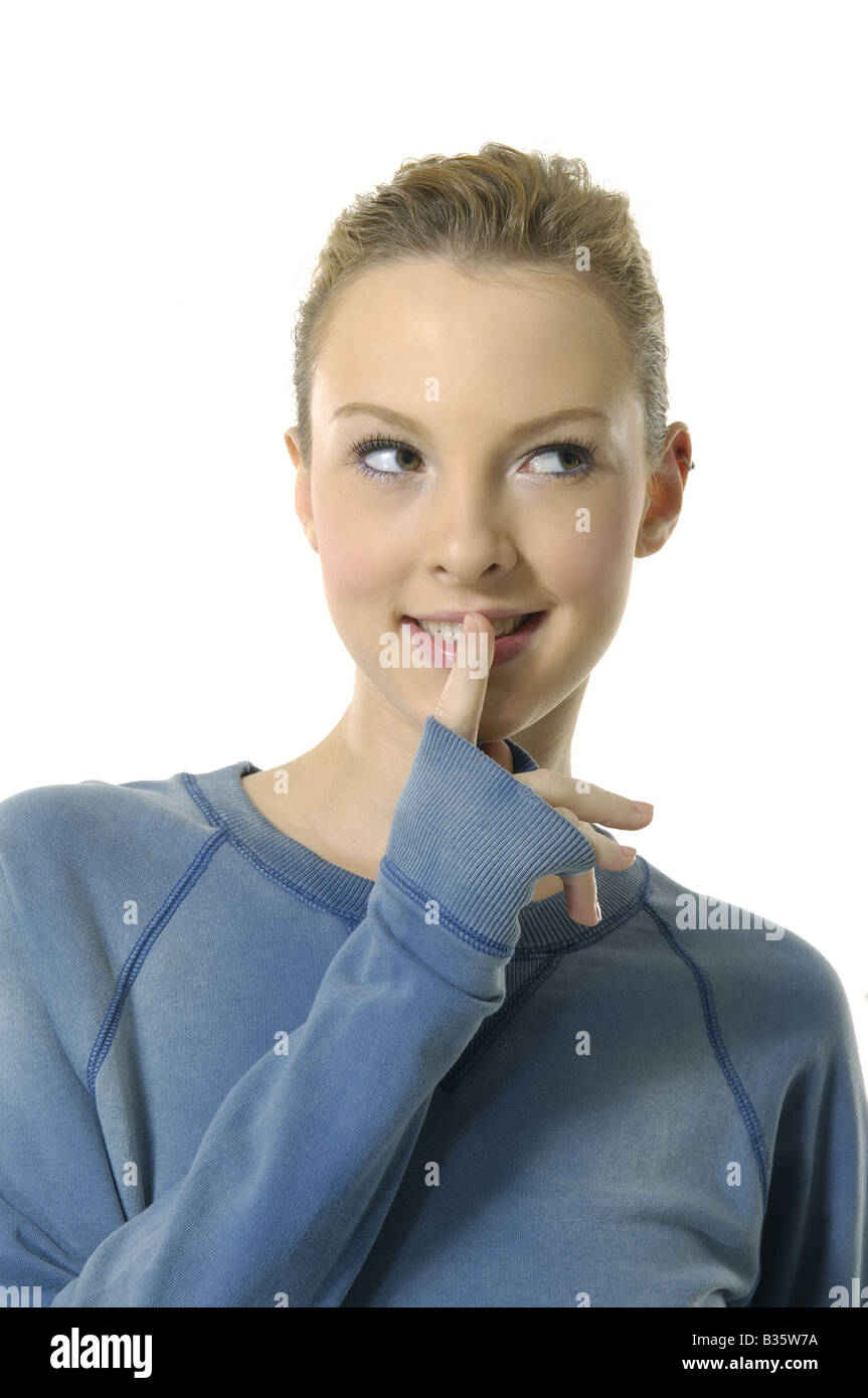 Close-up of a young woman smiling with her finger on her lips Stock ...