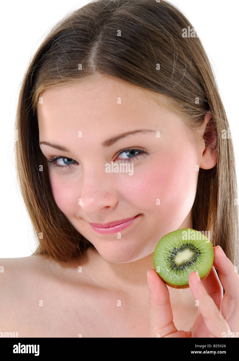 Portrait of a young woman holding a half kiwi fruit Stock Photo - Alamy