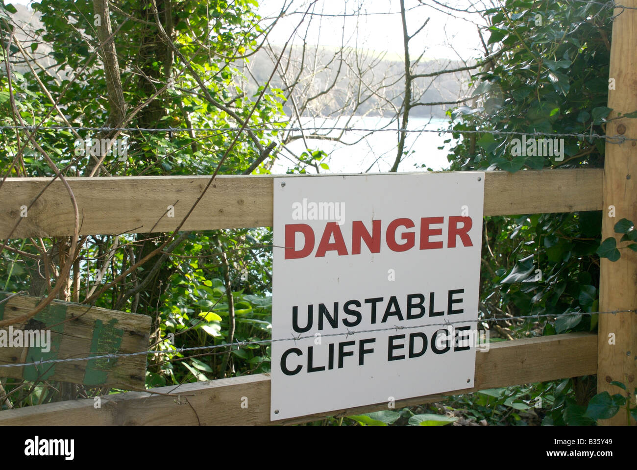 Danger notice unstable cliff edge, Salcombe, Devon, UK Stock Photo