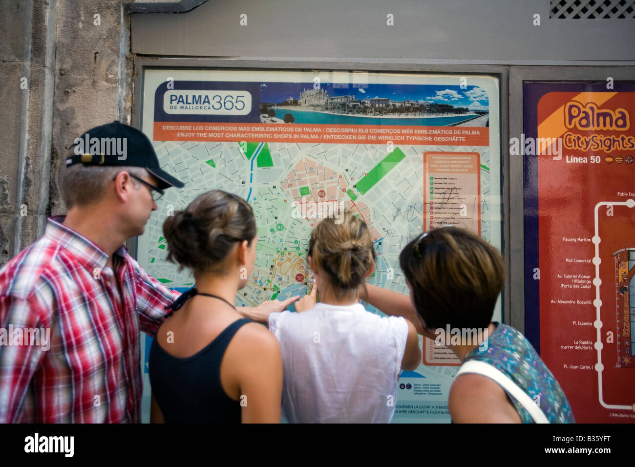 Family looking at a public map Palma de Mallorca Majorca Island Spain Stock Photo