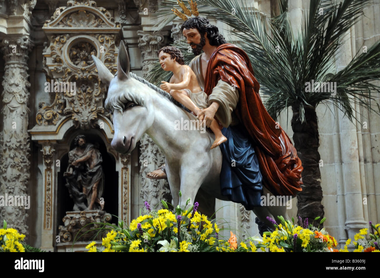 Polichrome wooden carving depicting Jesus Christ with a young boy child on a donkey kept in the New Cathedral Salamanca Spain Stock Photo