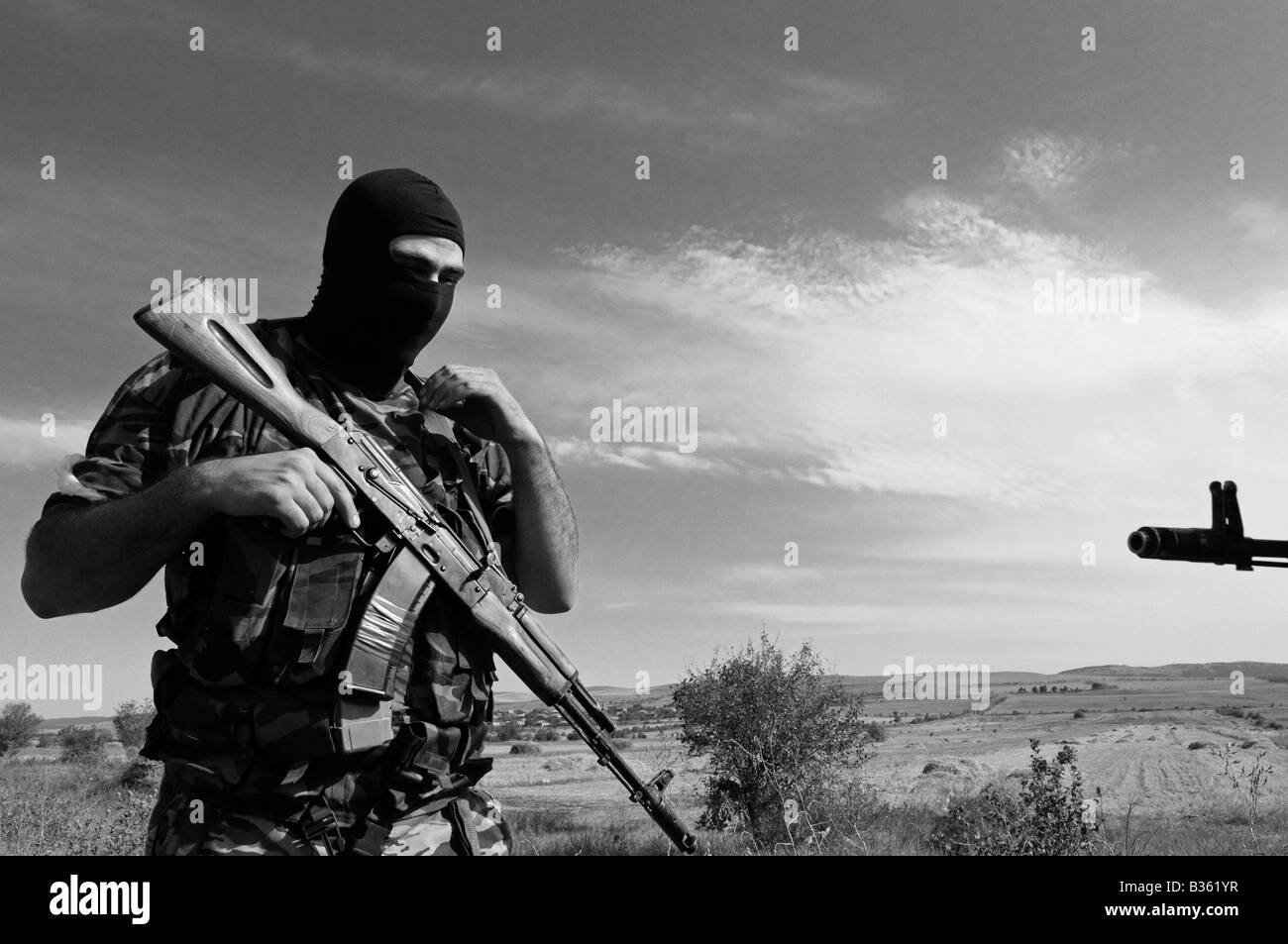 Member of Ossetian separatist militia wearing black balaclava armed with a Kalashnikov AK-47 near the city of Gori, during the Russo-Georgia war 2008 Stock Photo