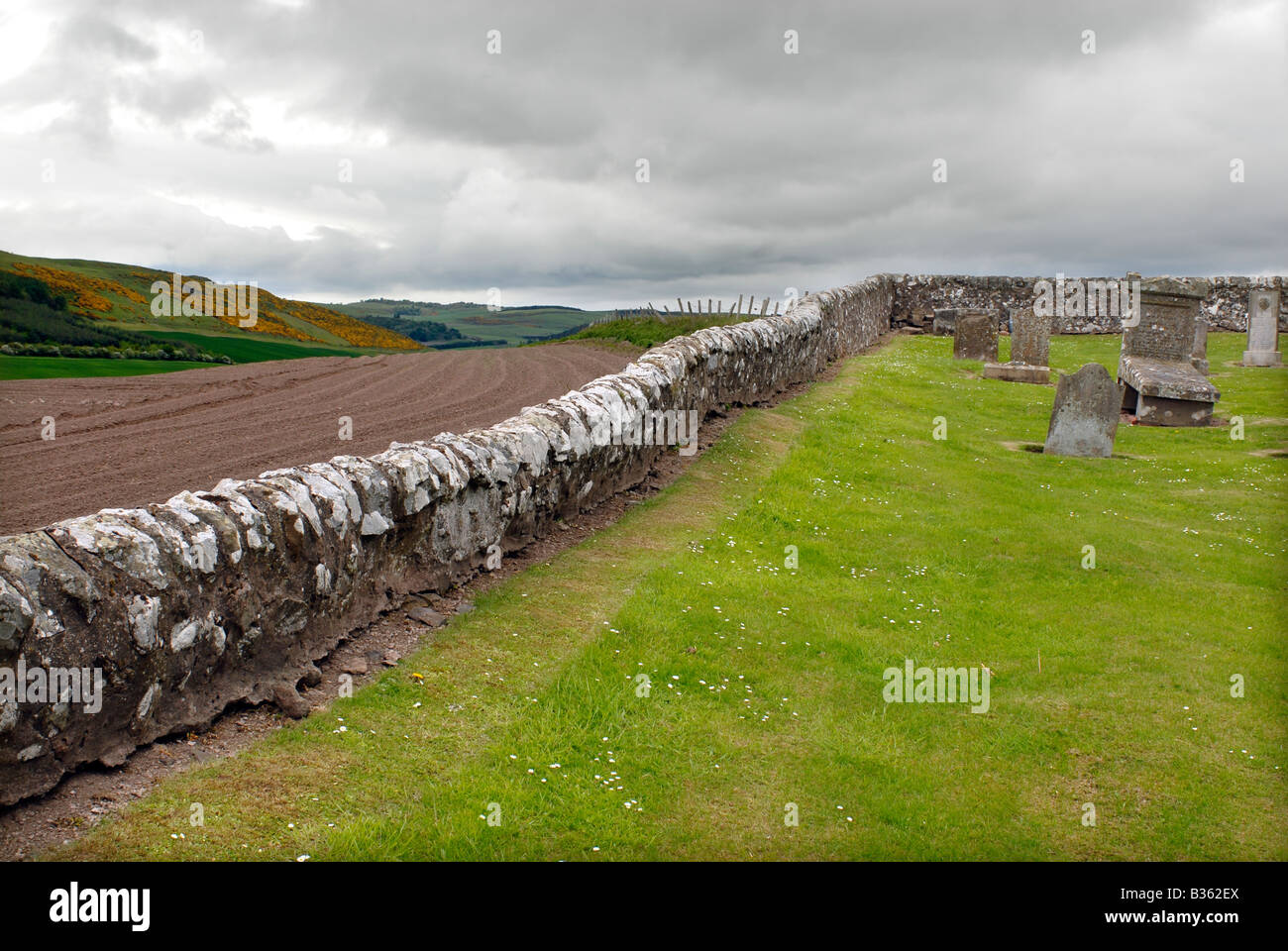 Cemetery wall and graveyard at Moonzie Church, Fife, Scotland Stock Photo