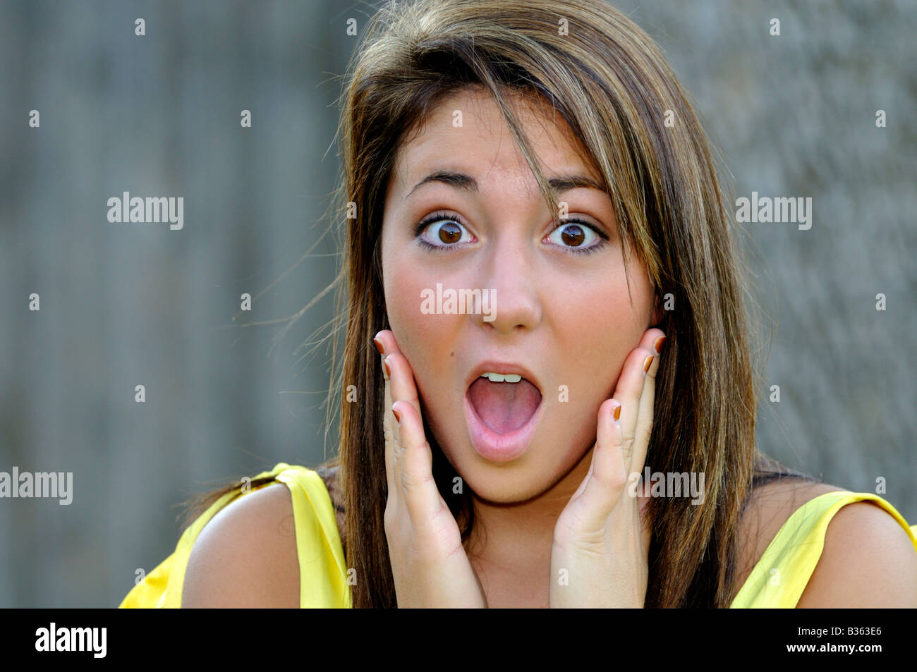 A 16 year old pretty caucasian girl shows a facial expression of shock and surprise. Stock Photo