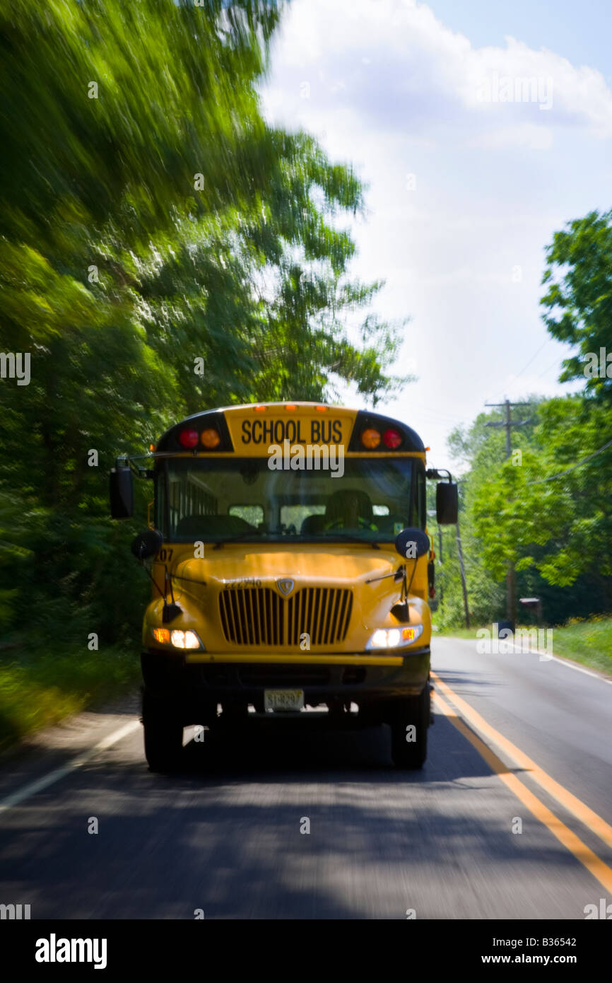 School bus driving down the road with motion blur. Stock Photo