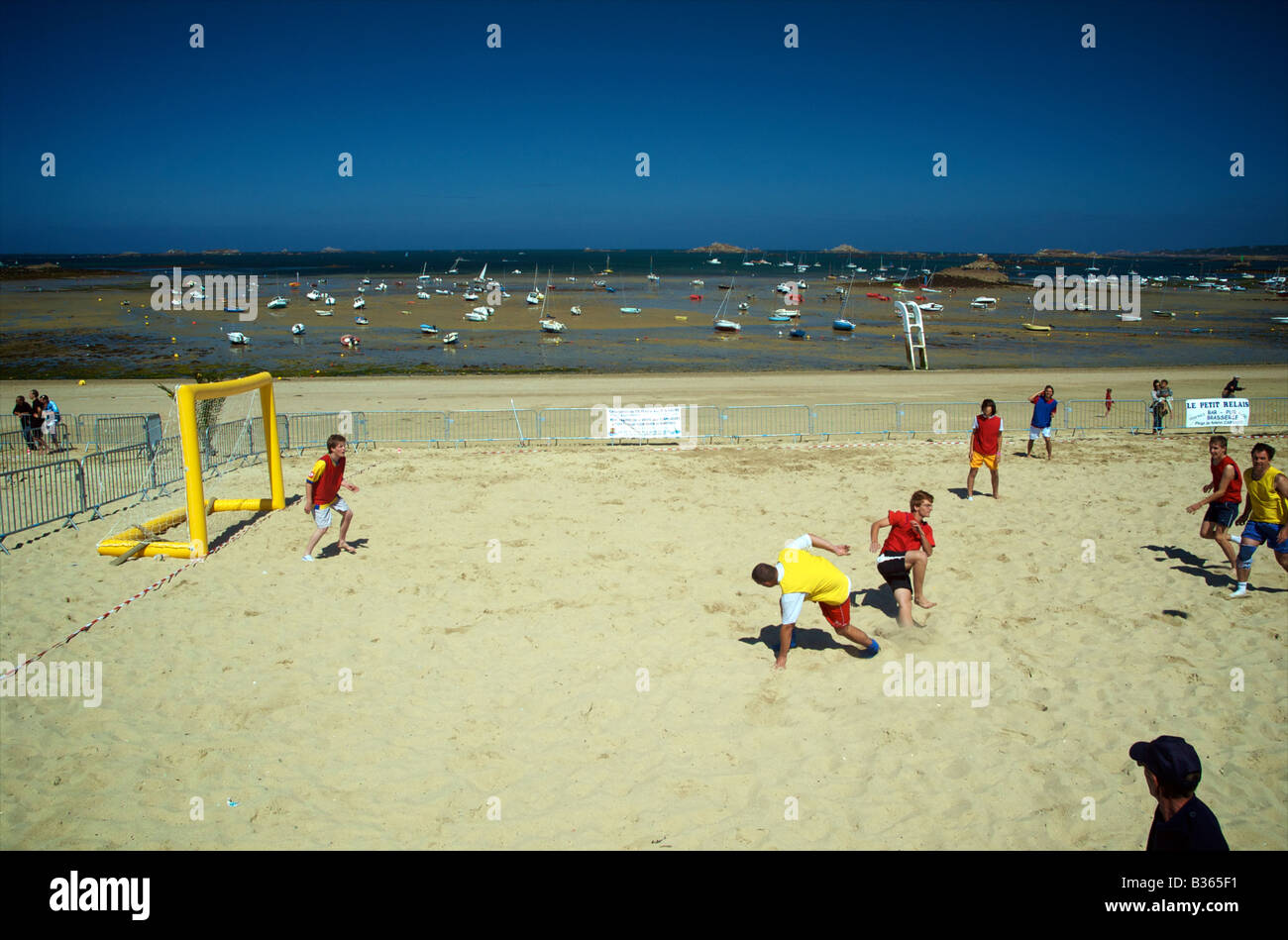 Young men playing beach football on Kelenn beach in Carantec Brittany France Stock Photo