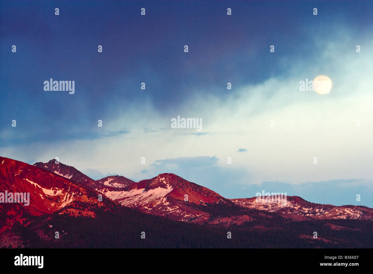 A full moon rises over the Yosemite back country as seen from Sentinel Dome Yosemite National Park California USA Stock Photo