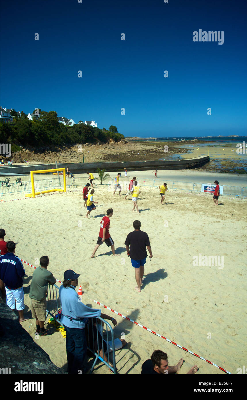 Young men playing beach football on Kelenn beach in Carantec Brittany France Stock Photo