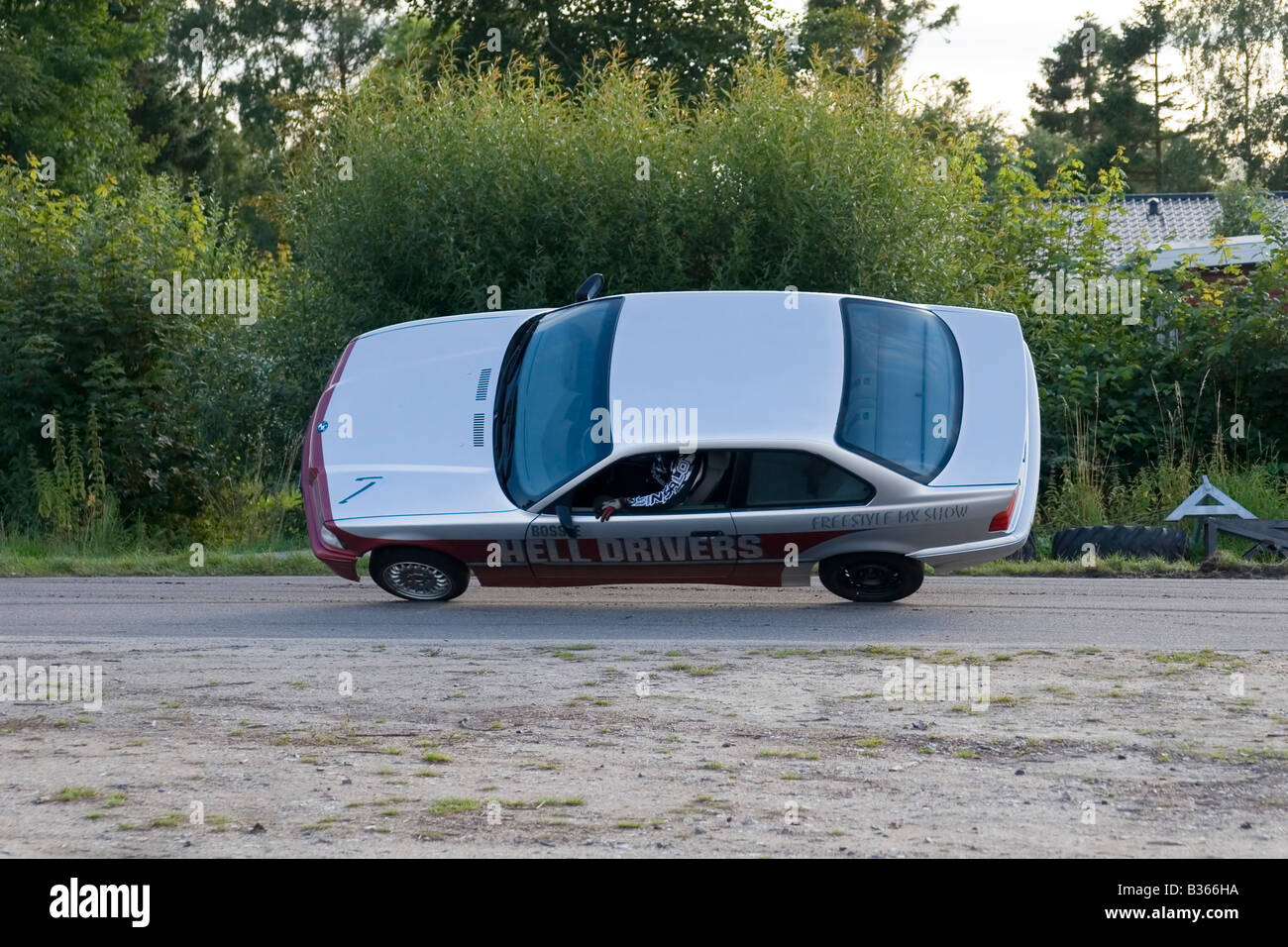BMW car on 2 wheels stunt Stock Photo Alamy